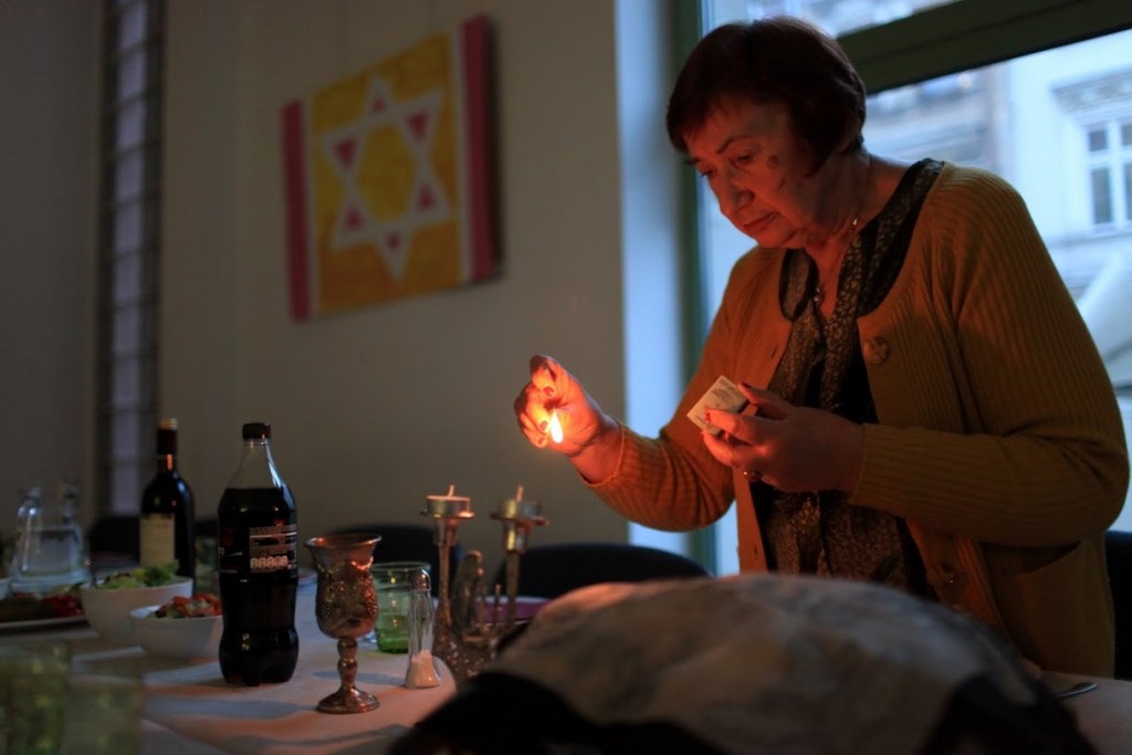 Holocaust survivor Zofia lights shabbat (sabbath) candles. Photo: JCC
